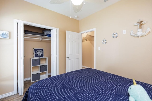 bedroom featuring ceiling fan, a closet, and wood-type flooring