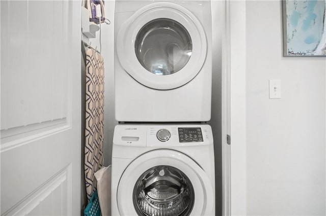 washroom featuring laundry area and stacked washing maching and dryer