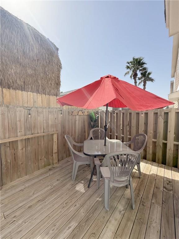 wooden deck featuring outdoor dining space and fence