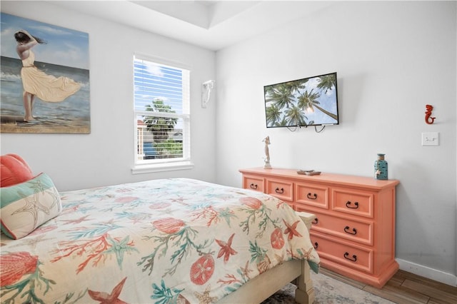 bedroom with light wood-style flooring and baseboards