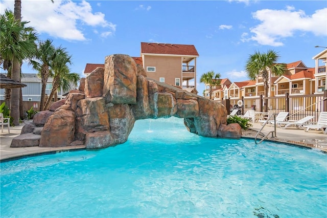 pool featuring a patio area, a residential view, and fence