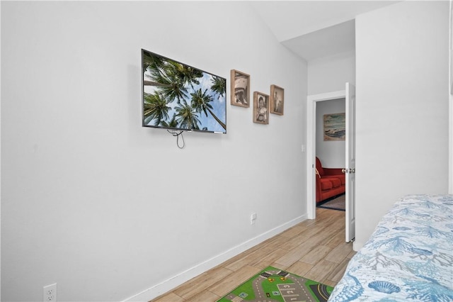 bedroom with baseboards and light wood-type flooring