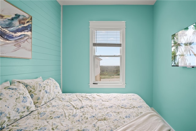 bedroom with wood walls