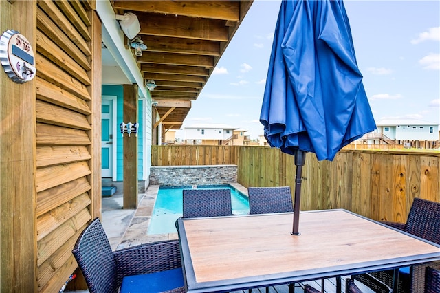 wooden terrace featuring a patio area and a swimming pool