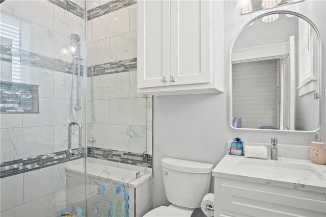 bathroom with toilet, vanity, and walk in shower