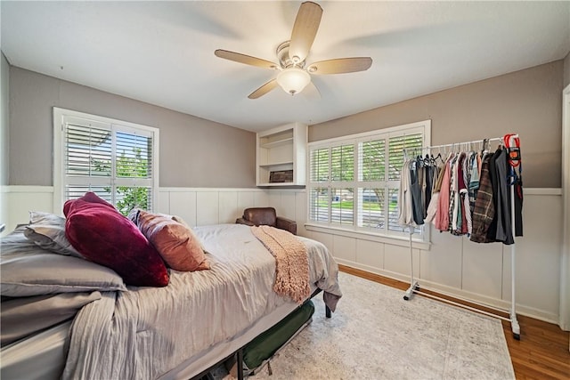 622 Bermuda Pl, Corpus Christi, TX 78411 - bedroom with wood finished floors, wainscoting, and a ceiling fan