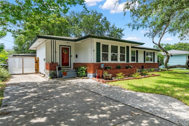 622 Bermuda Pl, Corpus Christi, TX 78411 - view of front of property with a front lawn, brick siding, concrete driveway, and entry steps