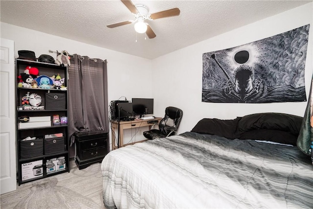 carpeted bedroom featuring ceiling fan and a textured ceiling