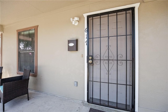 doorway to property with stucco siding