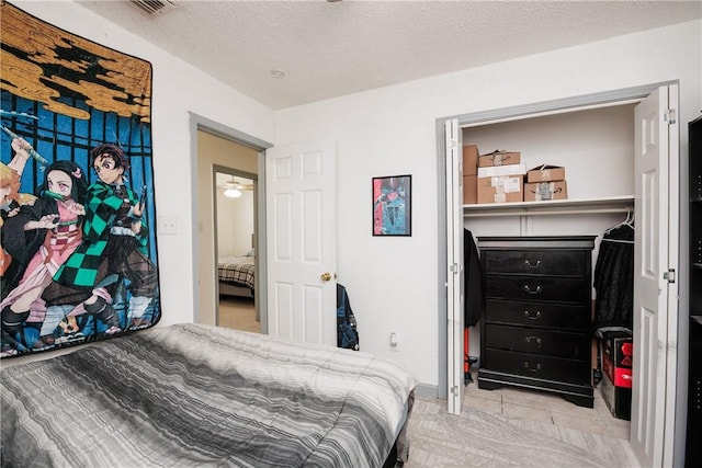 bedroom featuring a textured ceiling and light tile patterned floors