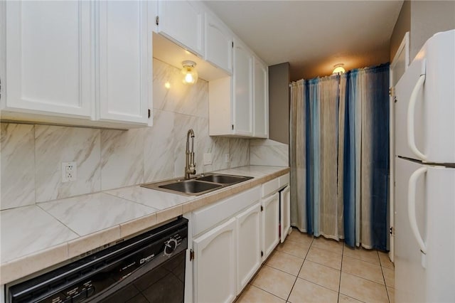 7202 Mansions Dr Unit N1, Corpus Christi, TX 78414 - kitchen with freestanding refrigerator, black dishwasher, a sink, and white cabinetry