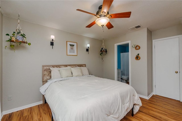 7202 Mansions Dr Unit N1, Corpus Christi, TX 78414 - bedroom with baseboards, ensuite bathroom, visible vents, and light wood-style floors