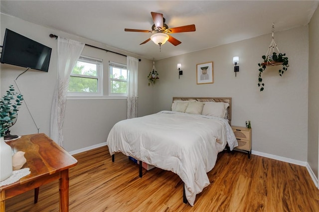 7202 Mansions Dr Unit N1, Corpus Christi, TX 78414 - bedroom with a ceiling fan, baseboards, and light wood-type flooring