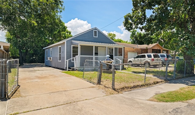 view of front of property with a garage, a porch, and a front yard