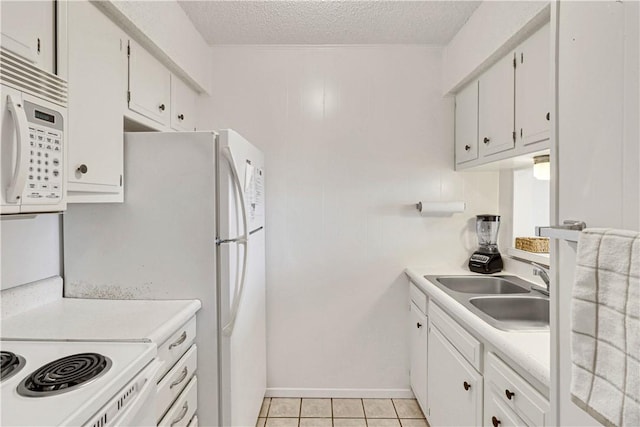 kitchen featuring white cabinets, a textured ceiling, light tile patterned flooring, and sink