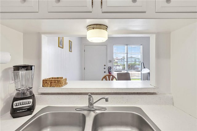 room details featuring white cabinetry and sink