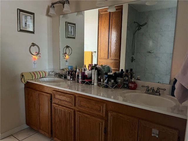 bathroom with tiled shower, tile patterned flooring, and vanity