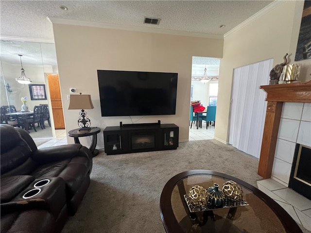 carpeted living room featuring a tiled fireplace, a textured ceiling, and ornamental molding