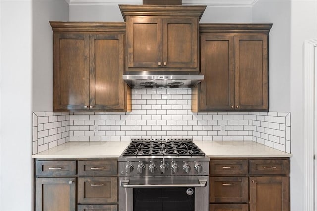 14013 Hawksnest Bay Dr, Corpus Christi, TX 78418 - kitchen featuring high end stove, light countertops, ornamental molding, under cabinet range hood, and tasteful backsplash