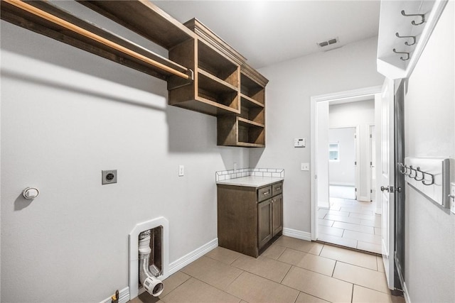 14013 Hawksnest Bay Dr, Corpus Christi, TX 78418 - laundry area with electric dryer hookup and light tile patterned flooring