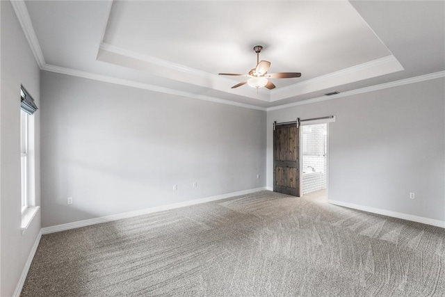 14013 Hawksnest Bay Dr, Corpus Christi, TX 78418 - carpeted empty room featuring a raised ceiling, a barn door, ceiling fan, and crown molding