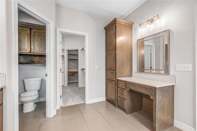 14013 Hawksnest Bay Dr, Corpus Christi, TX 78418 - full bath with vanity, a walk in closet, backsplash, and tile patterned flooring