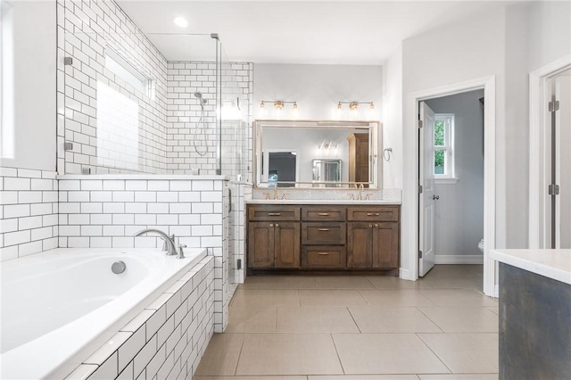 14013 Hawksnest Bay Dr, Corpus Christi, TX 78418 - full bathroom with double vanity, a bath, a stall shower, and tile patterned floors
