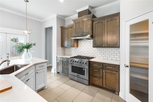 14013 Hawksnest Bay Dr, Corpus Christi, TX 78418 - kitchen featuring high end stainless steel range, light countertops, under cabinet range hood, ornamental molding, and backsplash