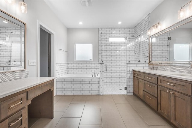 14013 Hawksnest Bay Dr, Corpus Christi, TX 78418 - full bathroom with double vanity, a bath, tile patterned floors, a shower stall, and recessed lighting