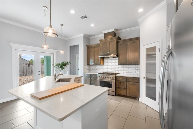 14013 Hawksnest Bay Dr, Corpus Christi, TX 78418 - kitchen with stainless steel appliances, a kitchen island with sink, french doors, backsplash, and light tile patterned flooring