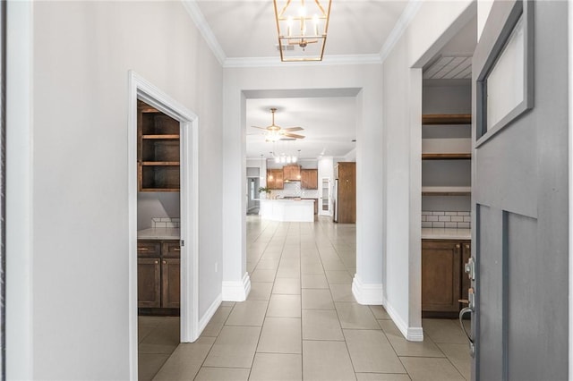14013 Hawksnest Bay Dr, Corpus Christi, TX 78418 - hall with light tile patterned floors, ornamental molding, and a chandelier