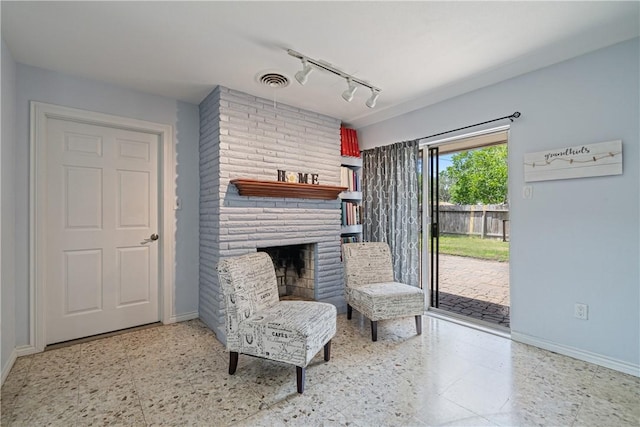 438 Pennington Dr, Corpus Christi, TX 78412 - sitting room with rail lighting, baseboards, and a fireplace