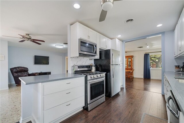 438 Pennington Dr, Corpus Christi, TX 78412 - kitchen with stainless steel appliances, a ceiling fan, recessed lighting, white cabinetry, and a peninsula