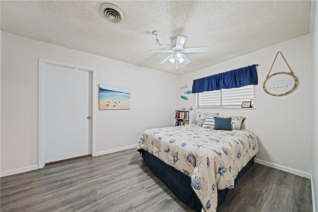 438 Pennington Dr, Corpus Christi, TX 78412 - bedroom with wood finished floors, a textured ceiling, baseboards, and a ceiling fan