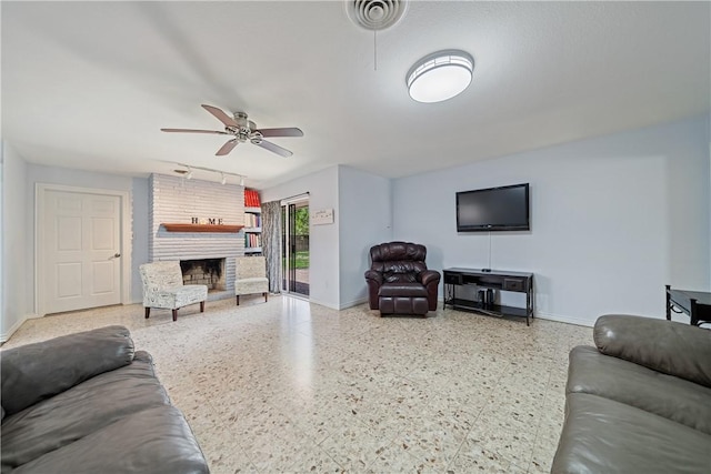 438 Pennington Dr, Corpus Christi, TX 78412 - living area featuring baseboards, a ceiling fan, a fireplace, and speckled floor