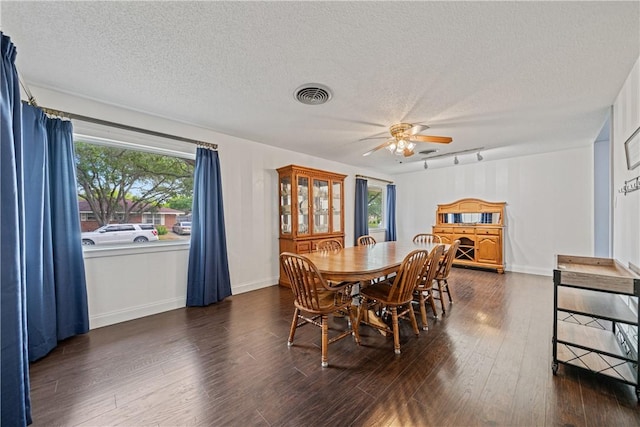438 Pennington Dr, Corpus Christi, TX 78412 - dining space with a textured ceiling, dark wood-type flooring, ceiling fan, rail lighting, and baseboards