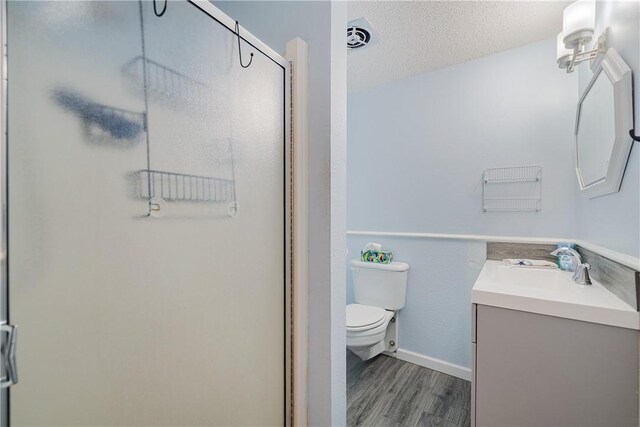 438 Pennington Dr, Corpus Christi, TX 78412 - full bath with vanity, wood finished floors, toilet, a stall shower, and a textured ceiling