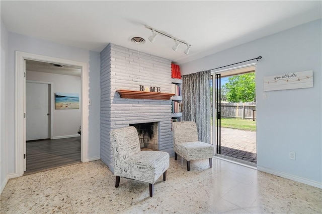 438 Pennington Dr, Corpus Christi, TX 78412 - living room with baseboards, rail lighting, and a fireplace