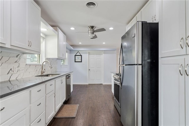 438 Pennington Dr, Corpus Christi, TX 78412 - kitchen with stainless steel appliances, a sink, ceiling fan, light stone countertops, and white cabinetry