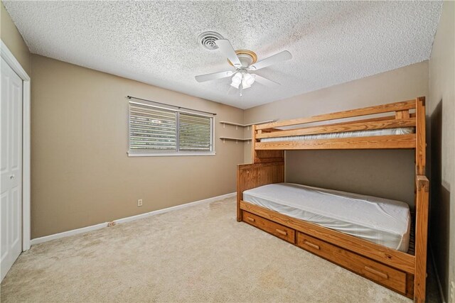 438 Pennington Dr, Corpus Christi, TX 78412 - unfurnished bedroom with carpet flooring, baseboards, a textured ceiling, ceiling fan, and a closet
