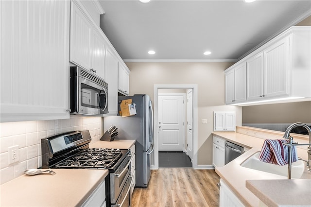 215 Sandollar Cir, Fulton, TX 78358 - kitchen featuring appliances with stainless steel finishes, a sink, white cabinets, light countertops, and tasteful backsplash