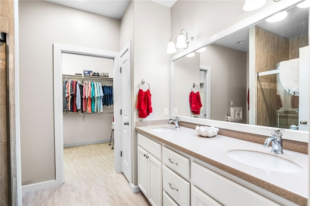 215 Sandollar Cir, Fulton, TX 78358 - full bath featuring a shower stall, double vanity, a walk in closet, and baseboards