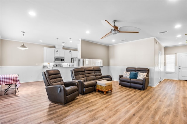 215 Sandollar Cir, Fulton, TX 78358 - living room with ornamental molding, light wood-style floors, a wainscoted wall, recessed lighting, and ceiling fan