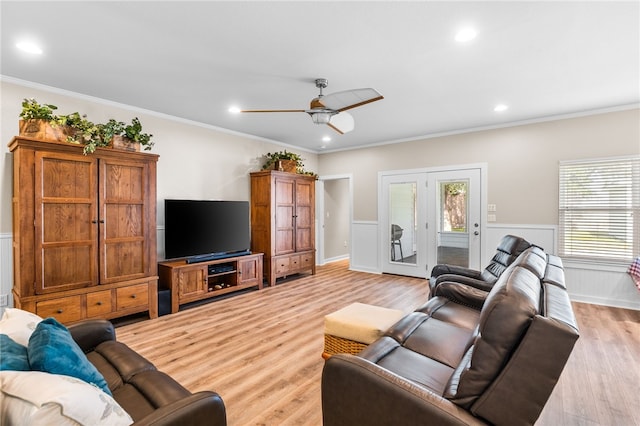 215 Sandollar Cir, Fulton, TX 78358 - living area with wainscoting, crown molding, ceiling fan, and light wood-style floors