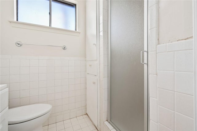 bathroom with toilet, tile walls, walk in shower, and vanity