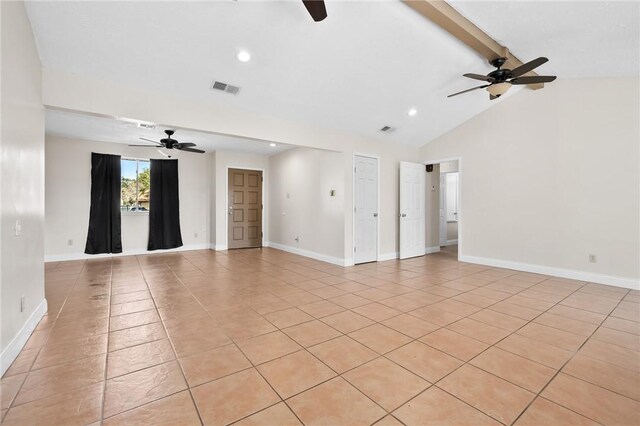 tiled spare room featuring vaulted ceiling with beams and ceiling fan