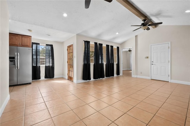 tiled empty room with vaulted ceiling with beams, ceiling fan, and a textured ceiling