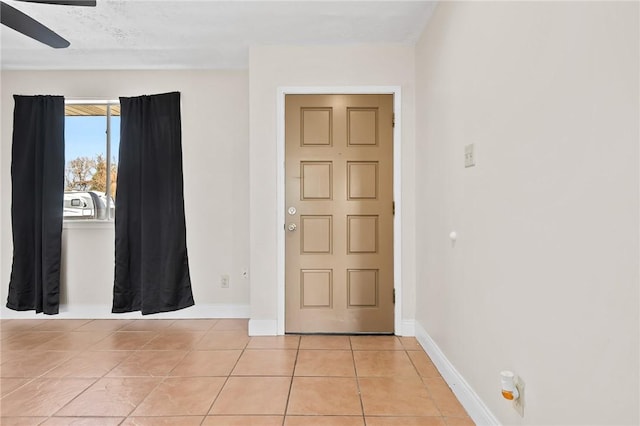 tiled entrance foyer with ceiling fan