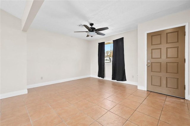 tiled spare room featuring ceiling fan