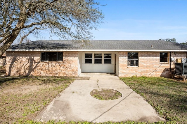 back of property featuring a yard and central AC